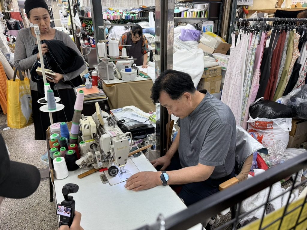 The CuraOnes team sourcing fabric at a market in Seoul, Korea